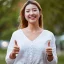 thumbs-up-happy-portrait-asian-woman-park-support-relaxing-happiness-outdoors-smile-nature-face-female-person-with-hand-gesture-agreement-thank-you-yes-sign